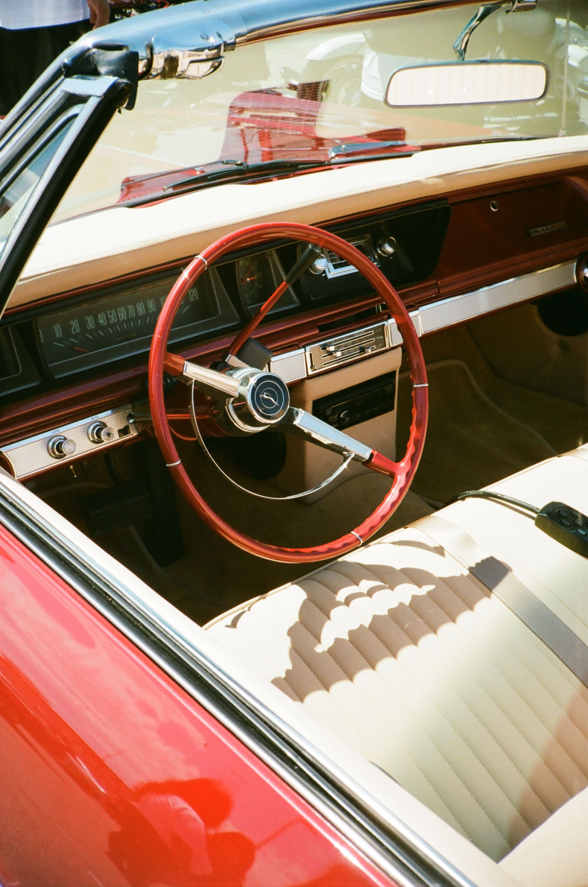 Interior view of a classic red Chevrolet Impala convertible with retro design features.