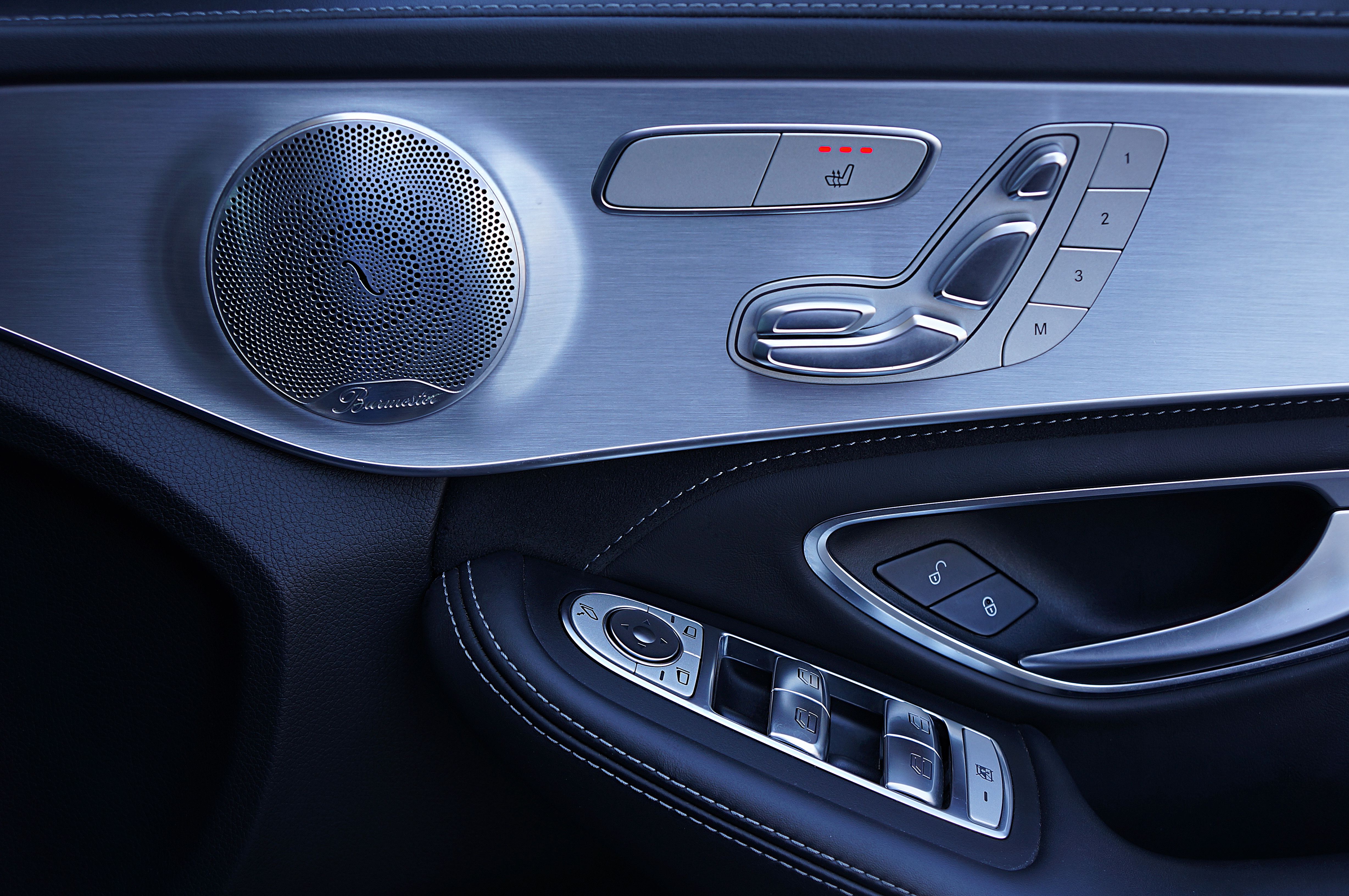 Sleek modern Mercedes-Benz car door showing speaker and control panel features.