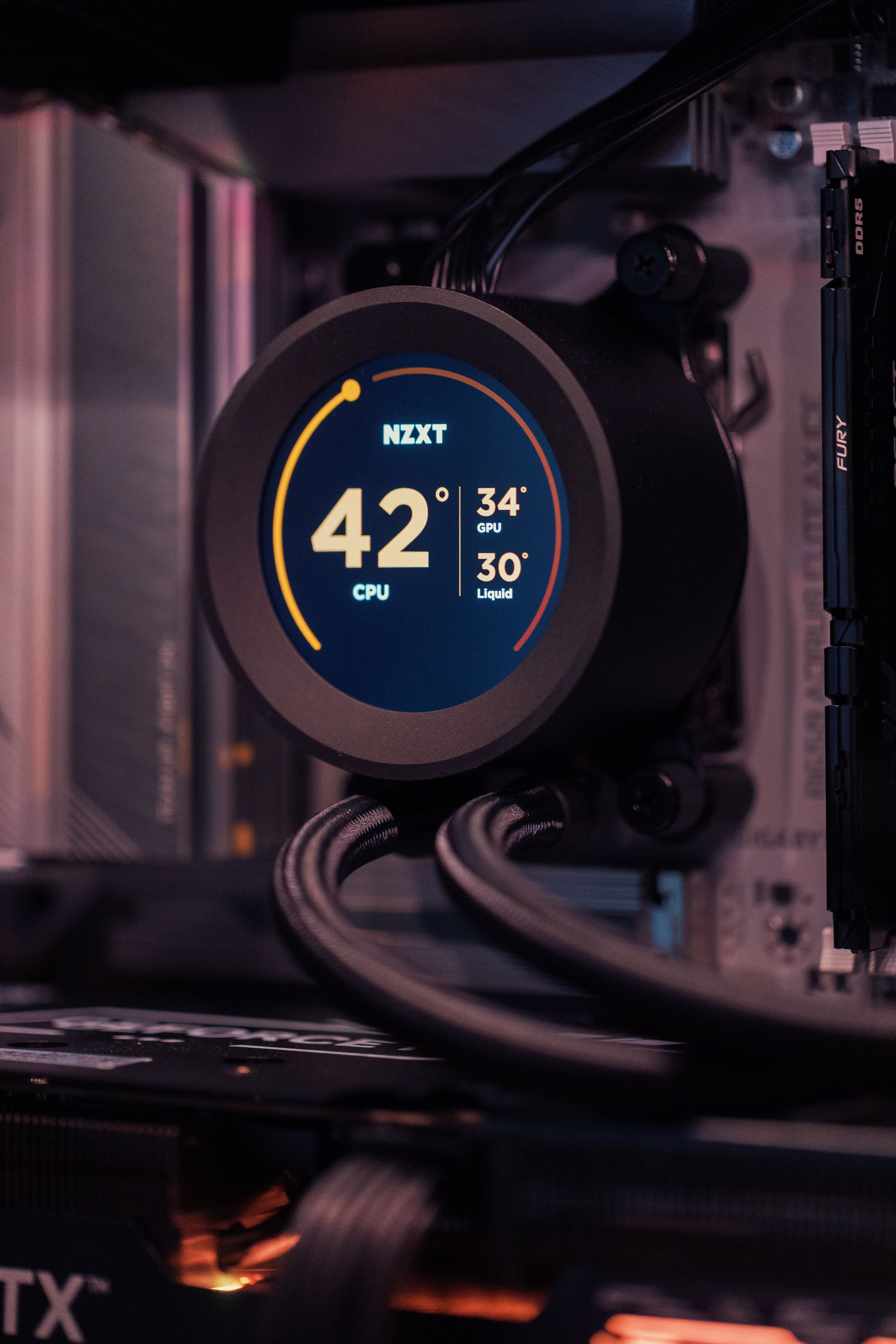 Close-up view of a modern computer cooling system with temperature display.