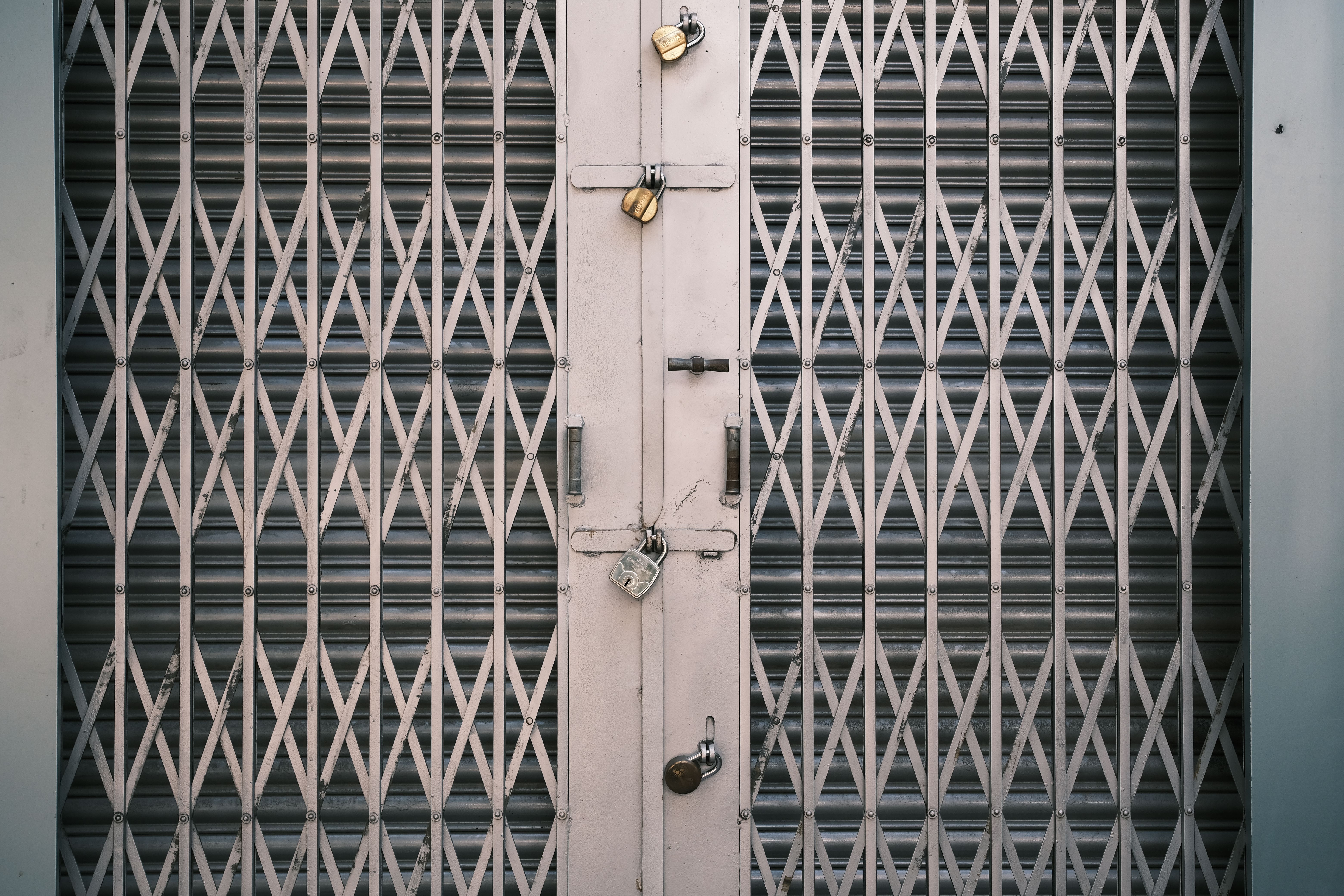 A secure metal gate with multiple locks in Bengaluru, India. Symbolizes security and protection.