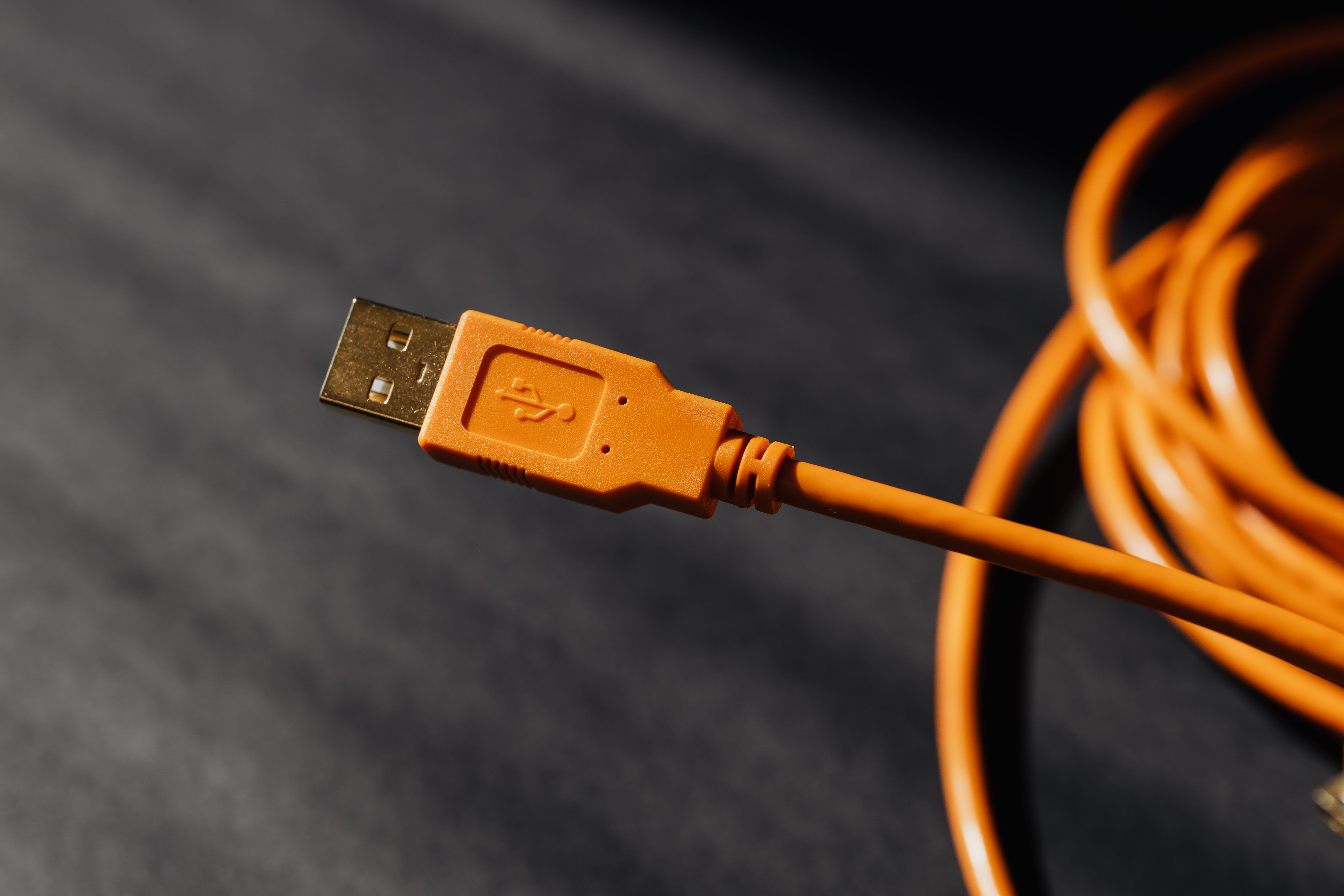 Detailed macro photo of an orange USB cable connector with focus on texture.