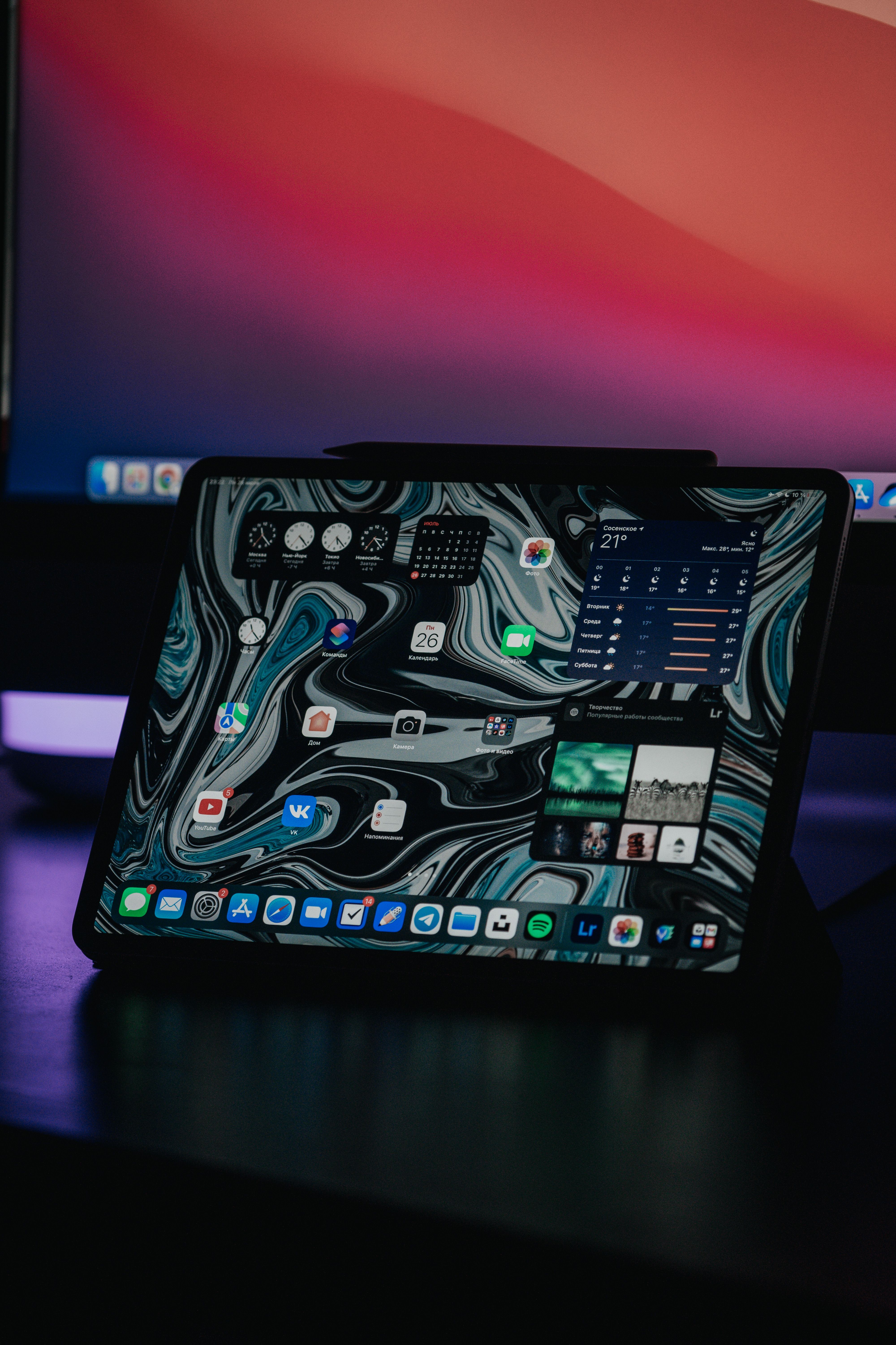 A modern tablet showcasing an abstract interface in a dimly lit environment, highlighting technology.