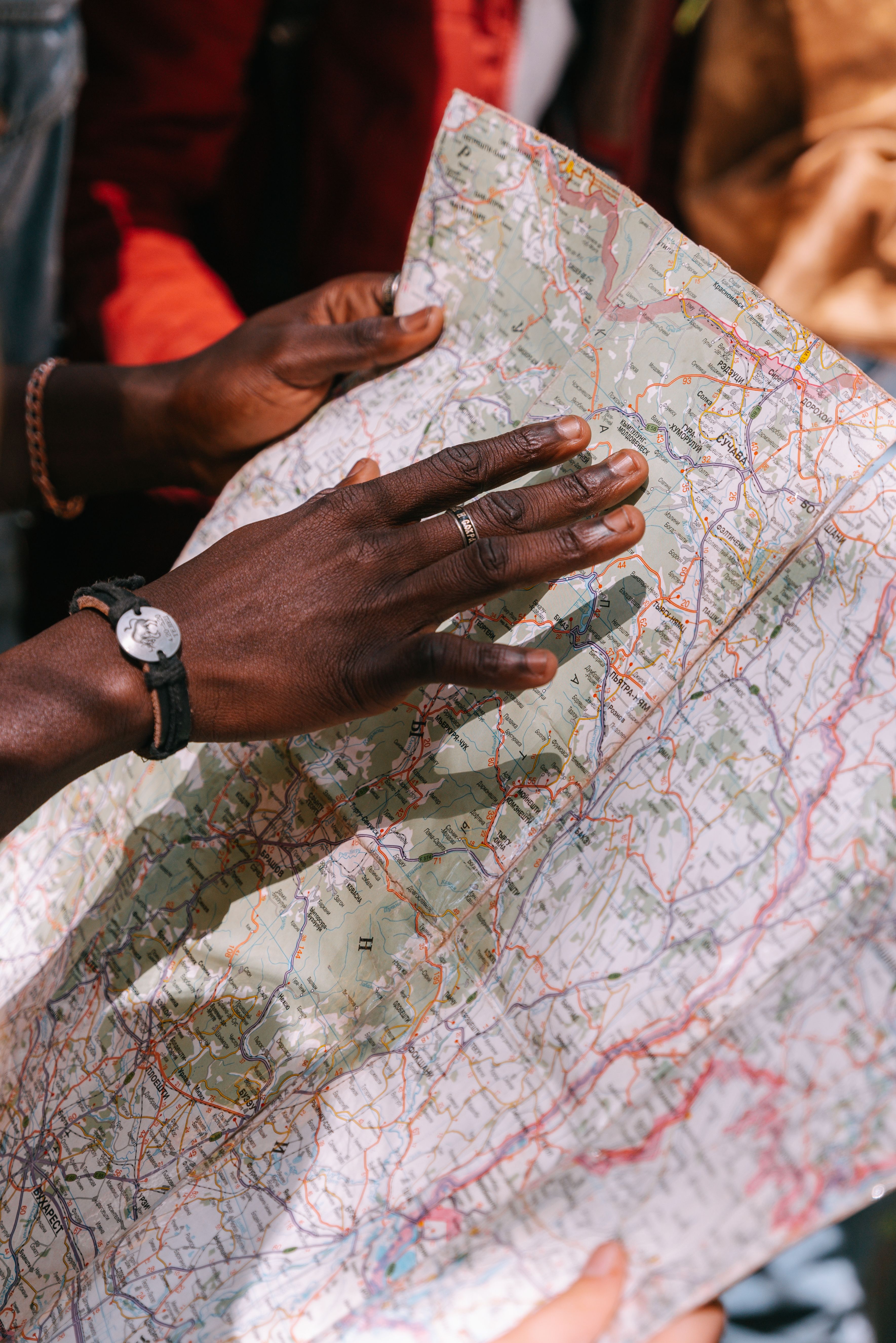 A close-up of a man's hands examining a map, perfect for travel and adventure themes.